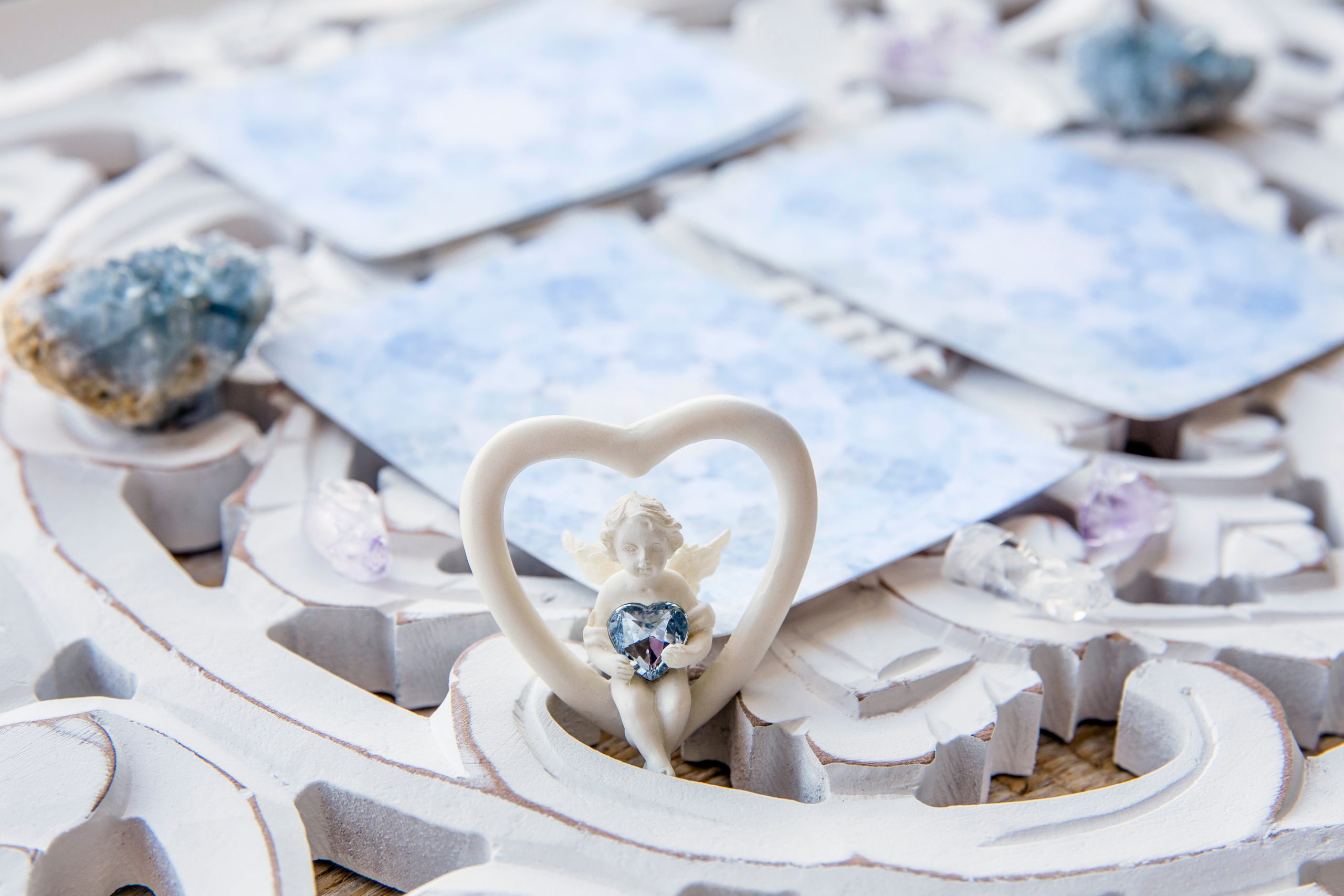 Deck with divination homemade Angel cards on bright white table,